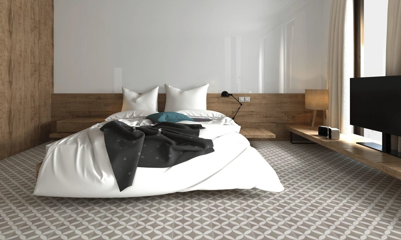 a bedroom with a bed and a grey and white tile floor.