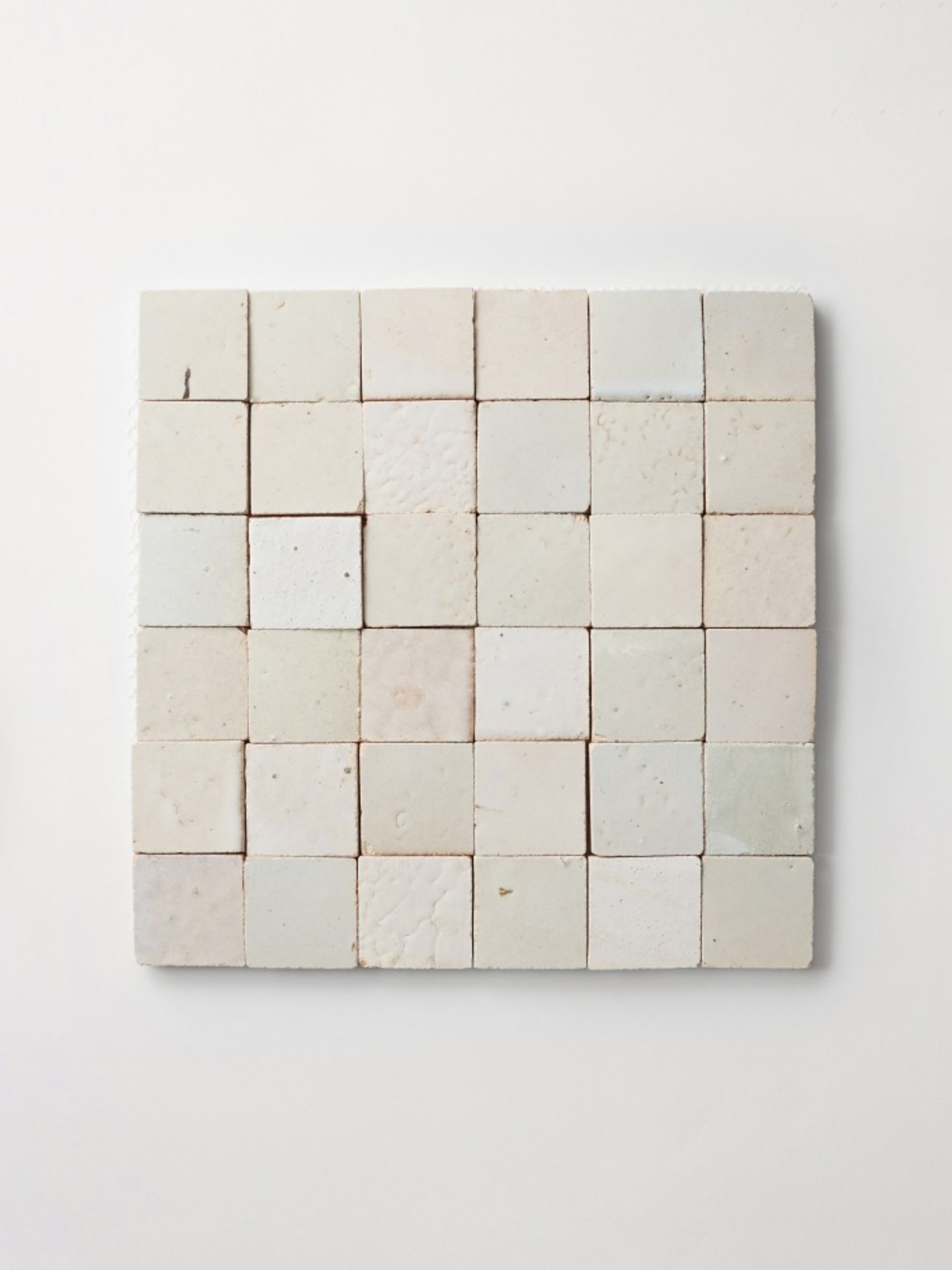 a white tile sheet on a white surface.