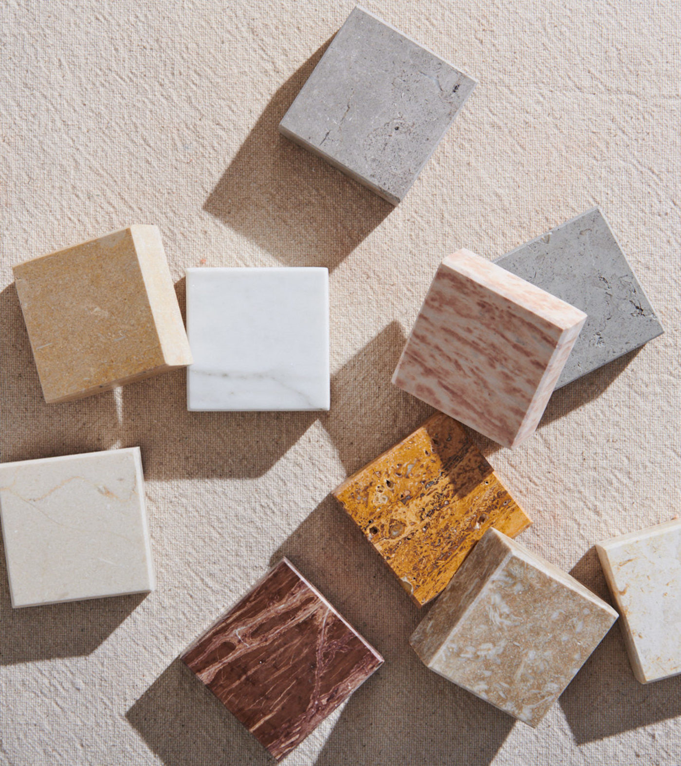 a group of marble slabs on a beige surface.