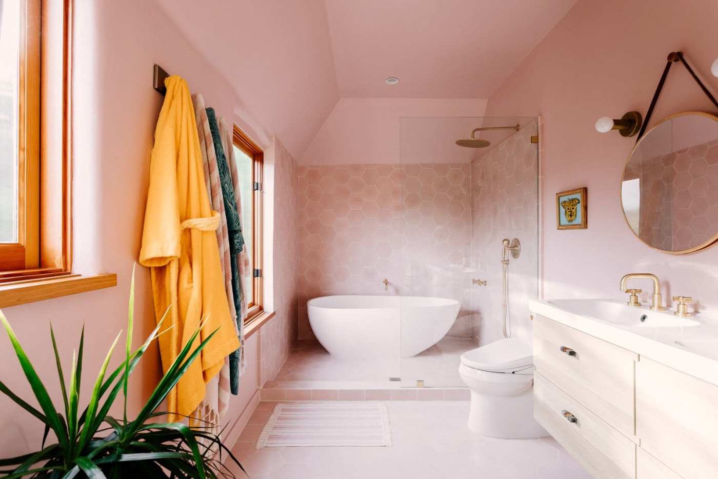 a bathroom with pink walls and a bathtub.