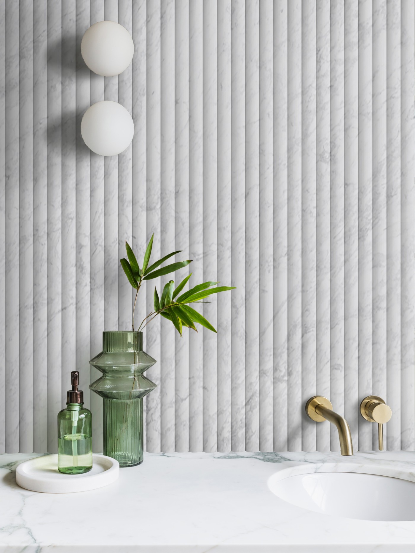 a bathroom with a marble wall and a green plant.