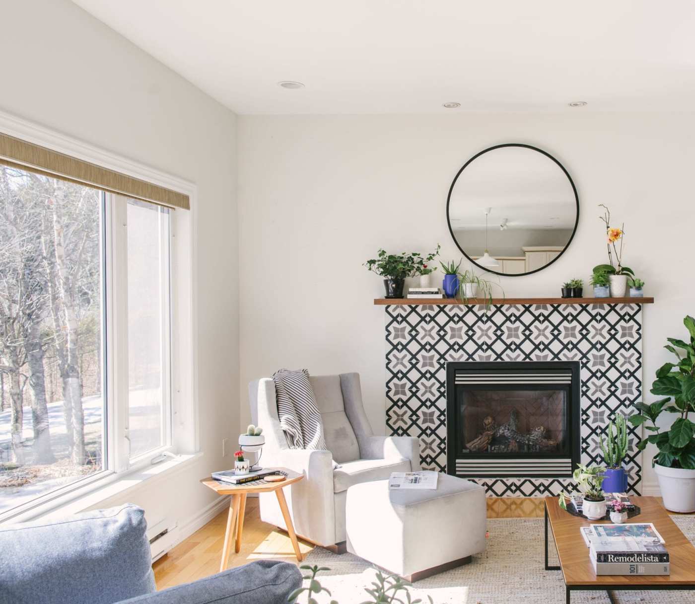 a living room with a fireplace and a rug.