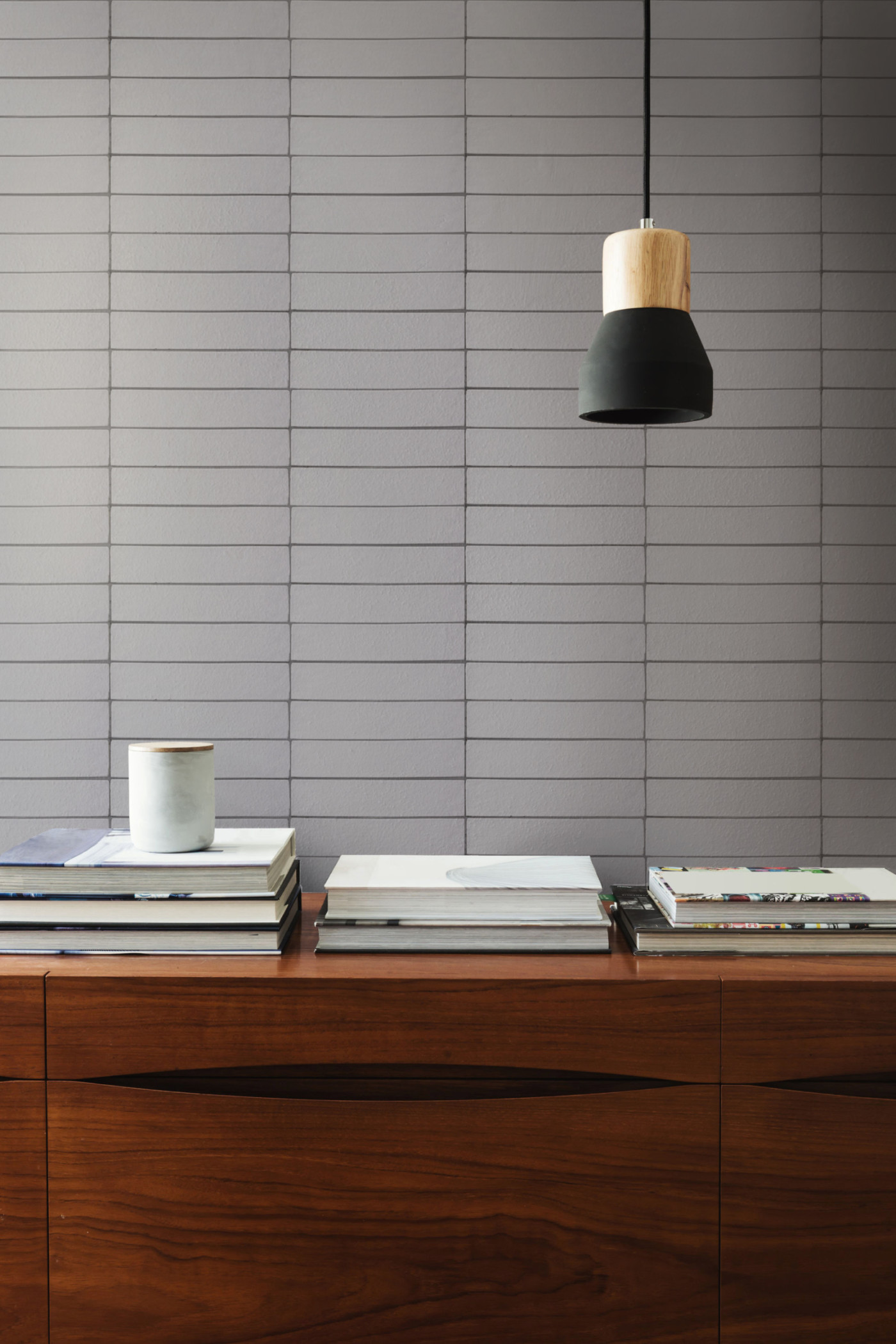 a desk with a lamp and books on it.