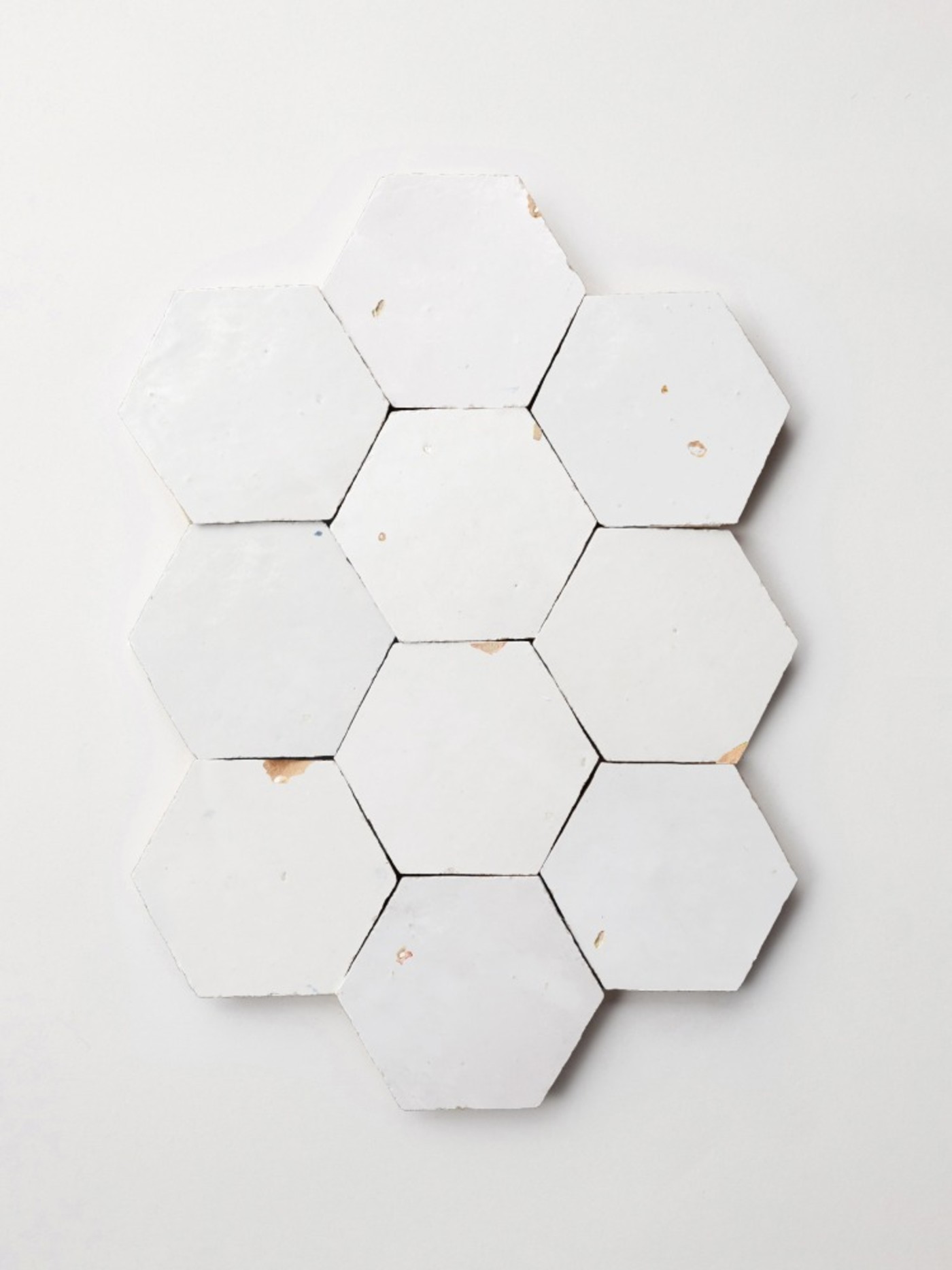 white hexagonal tiles on a white surface.