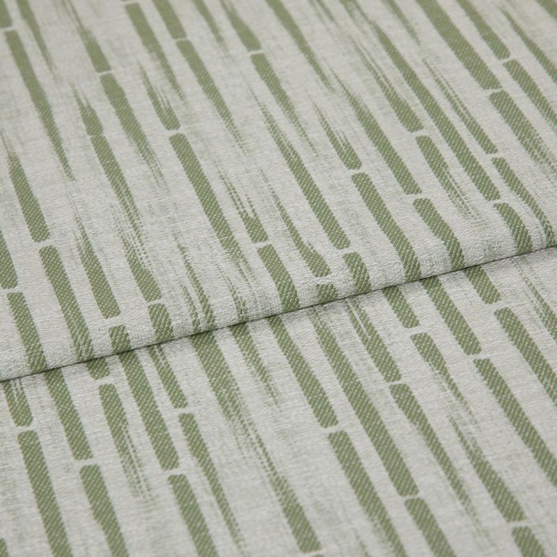 Textured upholstery fabric with vertical olive-green dashed stripes, folded once across the center creating an overlapping seam; close-up view with soft, even lighting and neutral, fabric-only background.