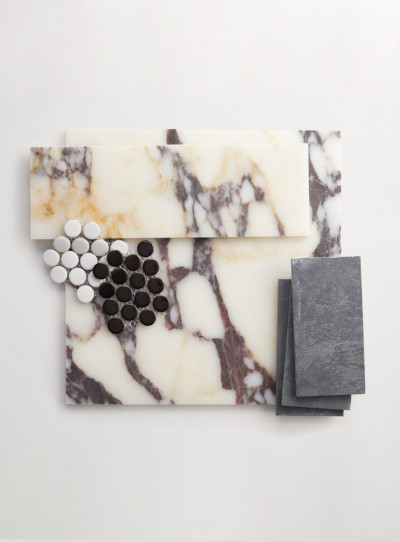 a marble cutting board with black and white marble pieces.