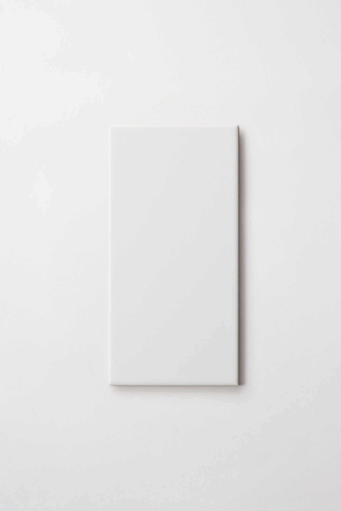 a white rectangle tile on a white surface.