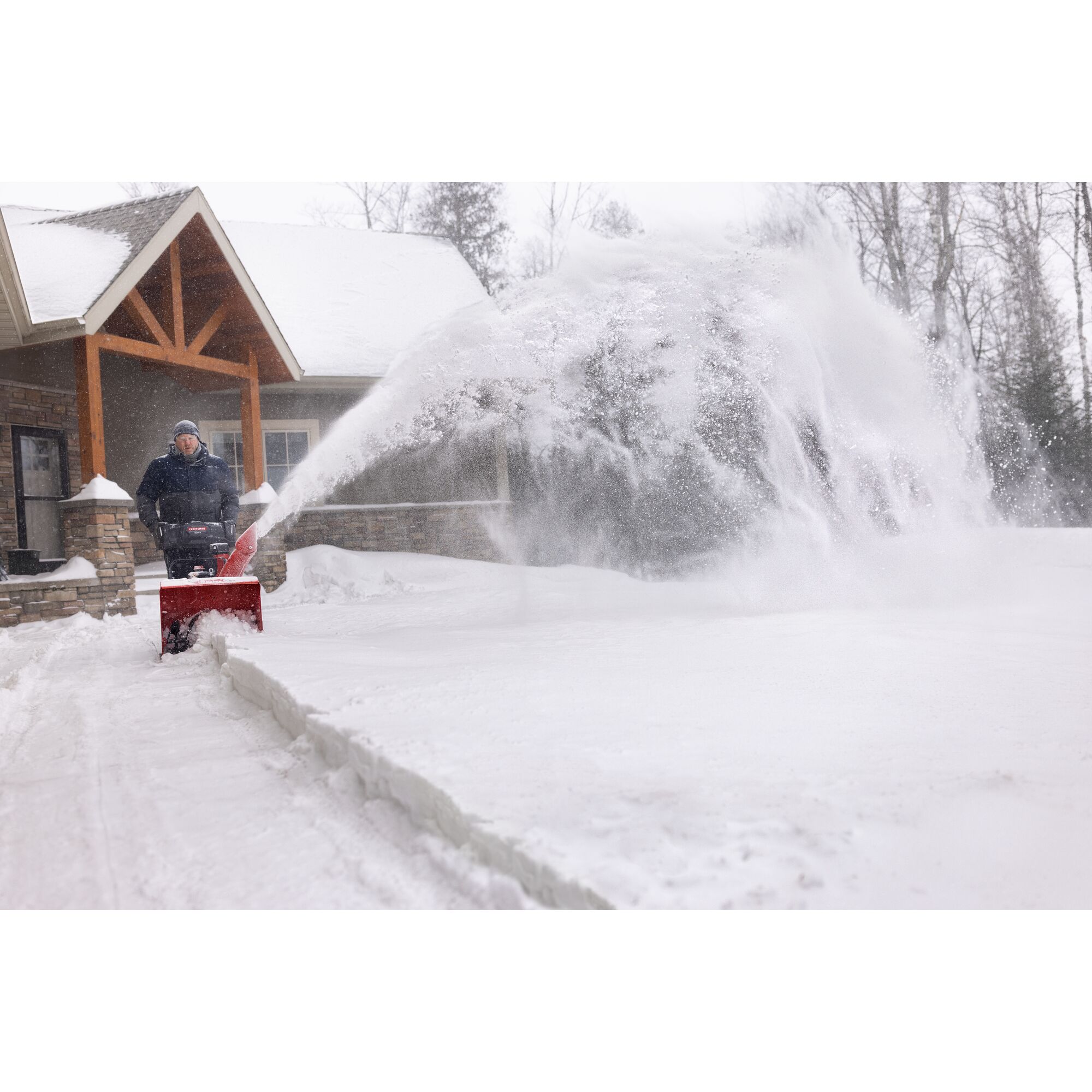 CRAFTSMAN Select 24 Snowblower clearing snow from sideway with house in background