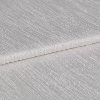 Textured ivory curtain fabric, folded over itself showing horizontal ribbed sheen; close-up view on a neutral surface with soft, diffuse lighting highlighting the weave.