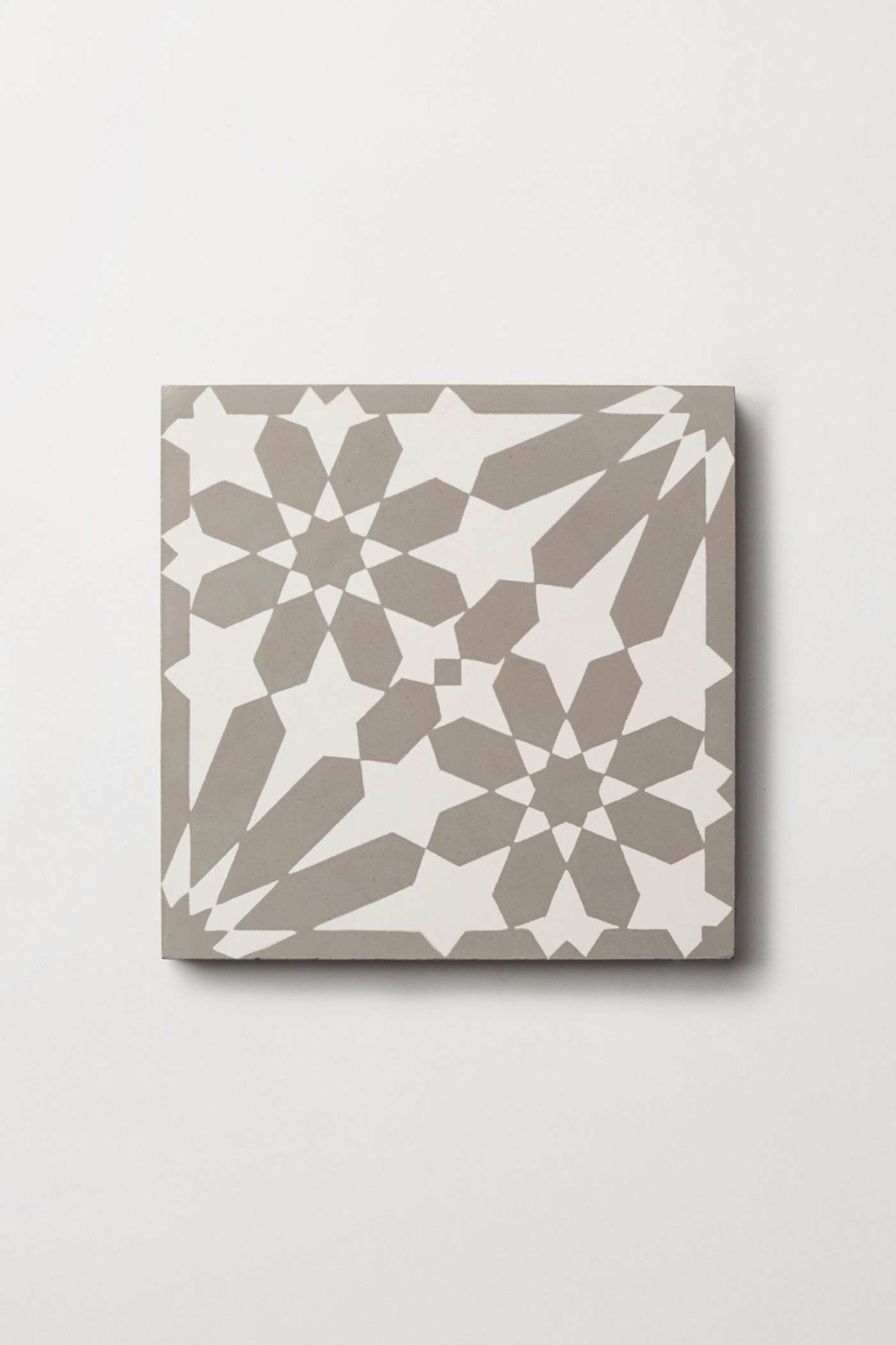 a grey and white tile on a white surface.