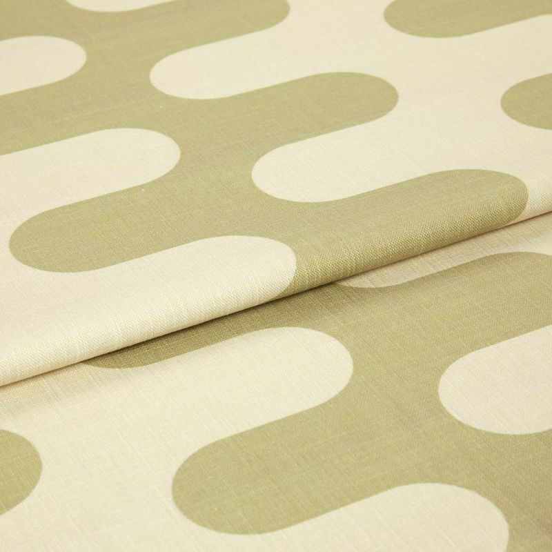 Fabric with large olive‑green rounded geometric motifs, folded and layered, showing woven texture and seams; studio‑lit close-up of a neutral‑colored textile sample.