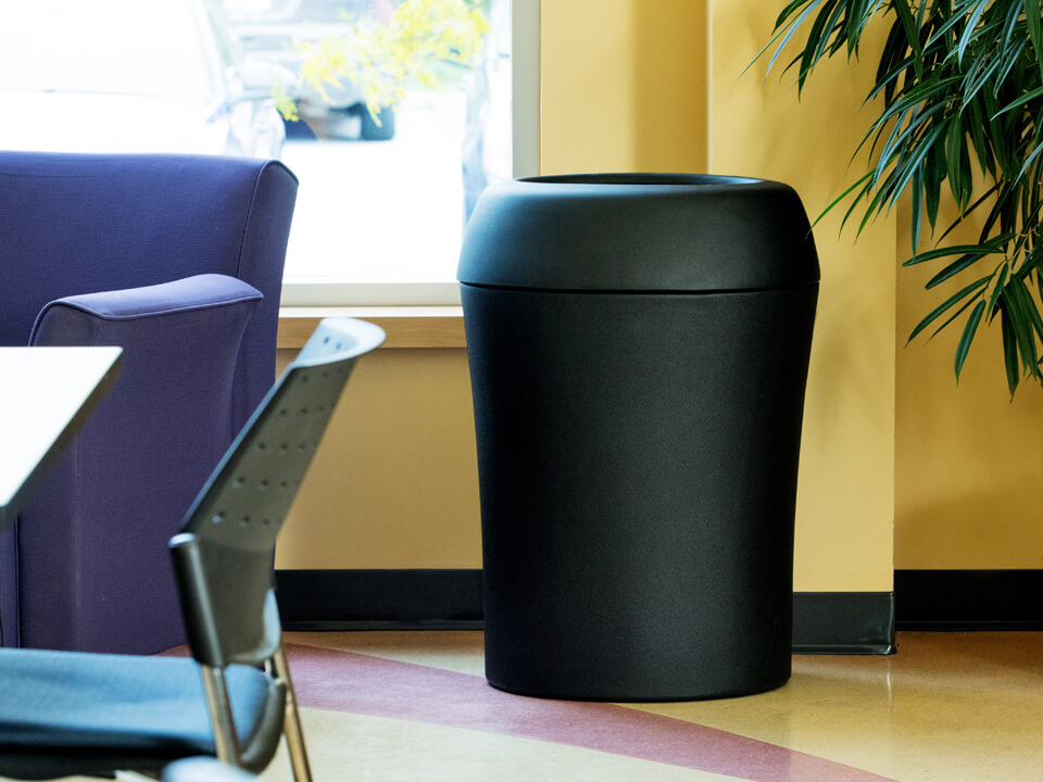 durable all black LDPE plastic waste container in a corporate office lunch room