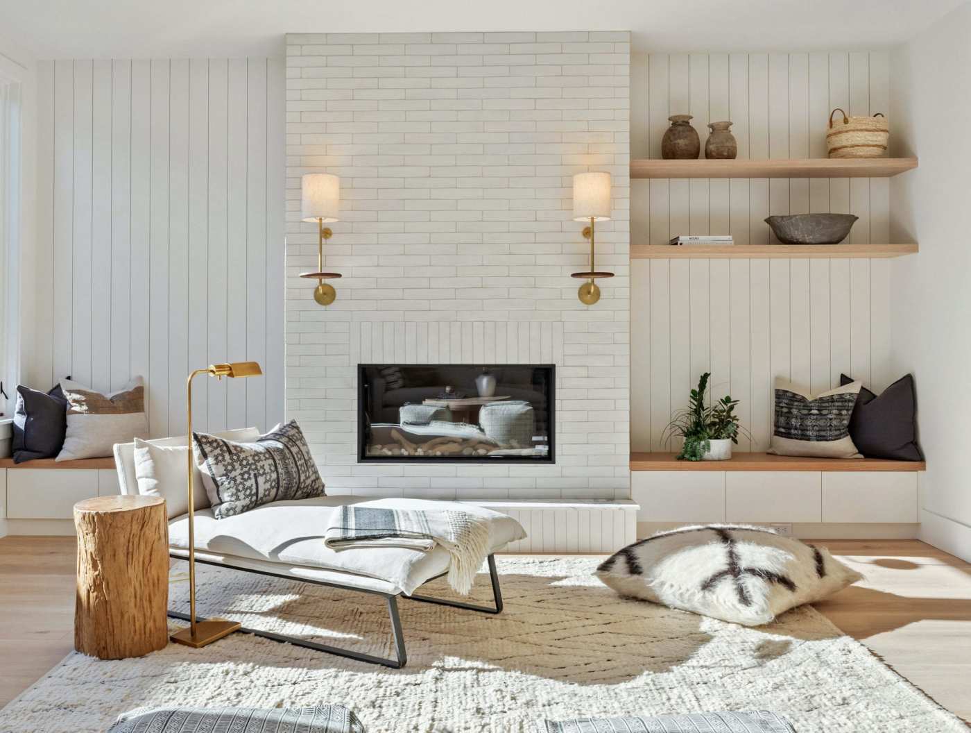 a living room with a chair and a white tiled fireplace.