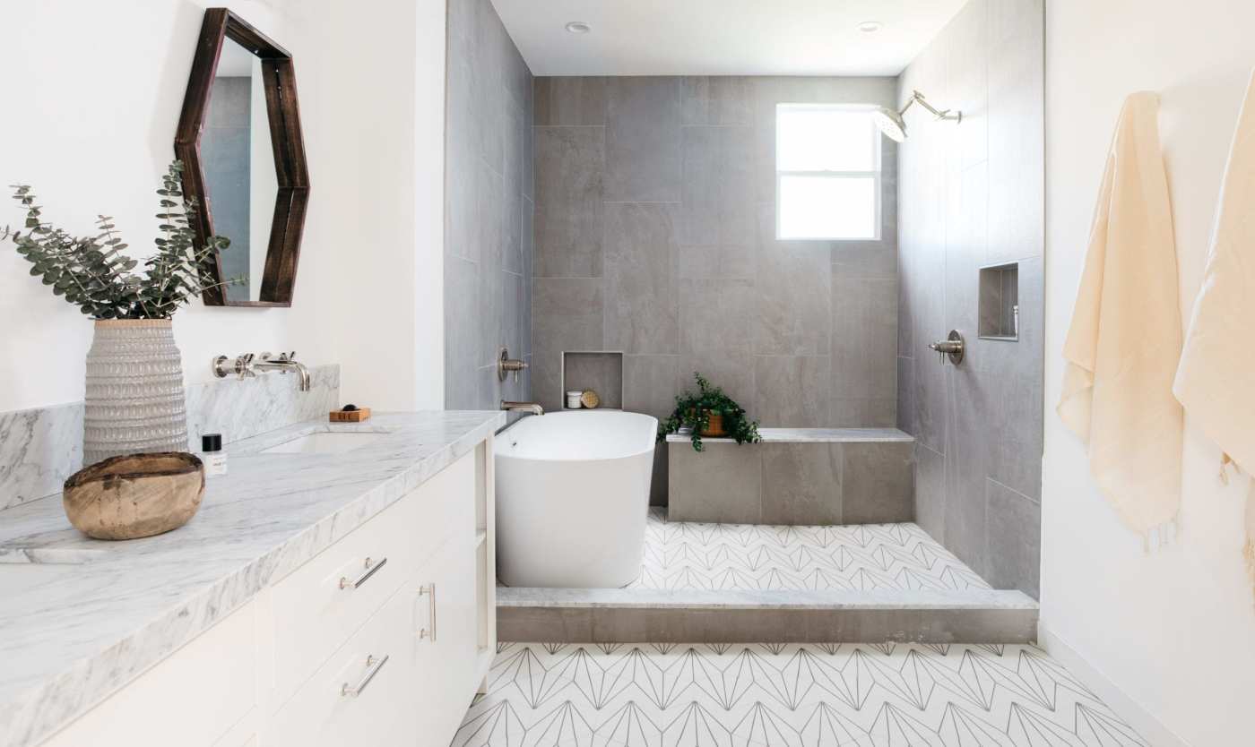 a modern bathroom with a white tub and sink.