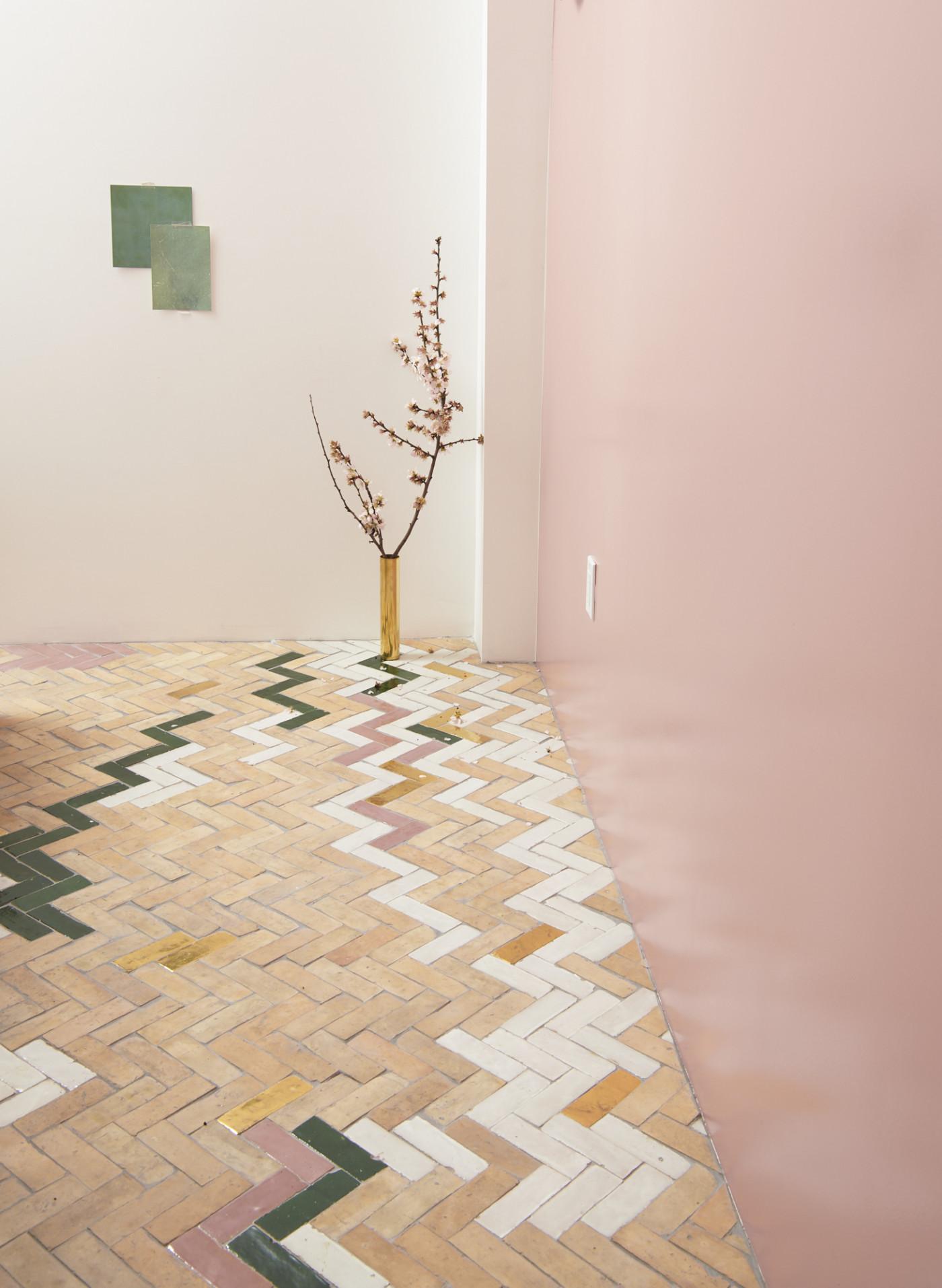 a room with a tile floor and pink and white walls.