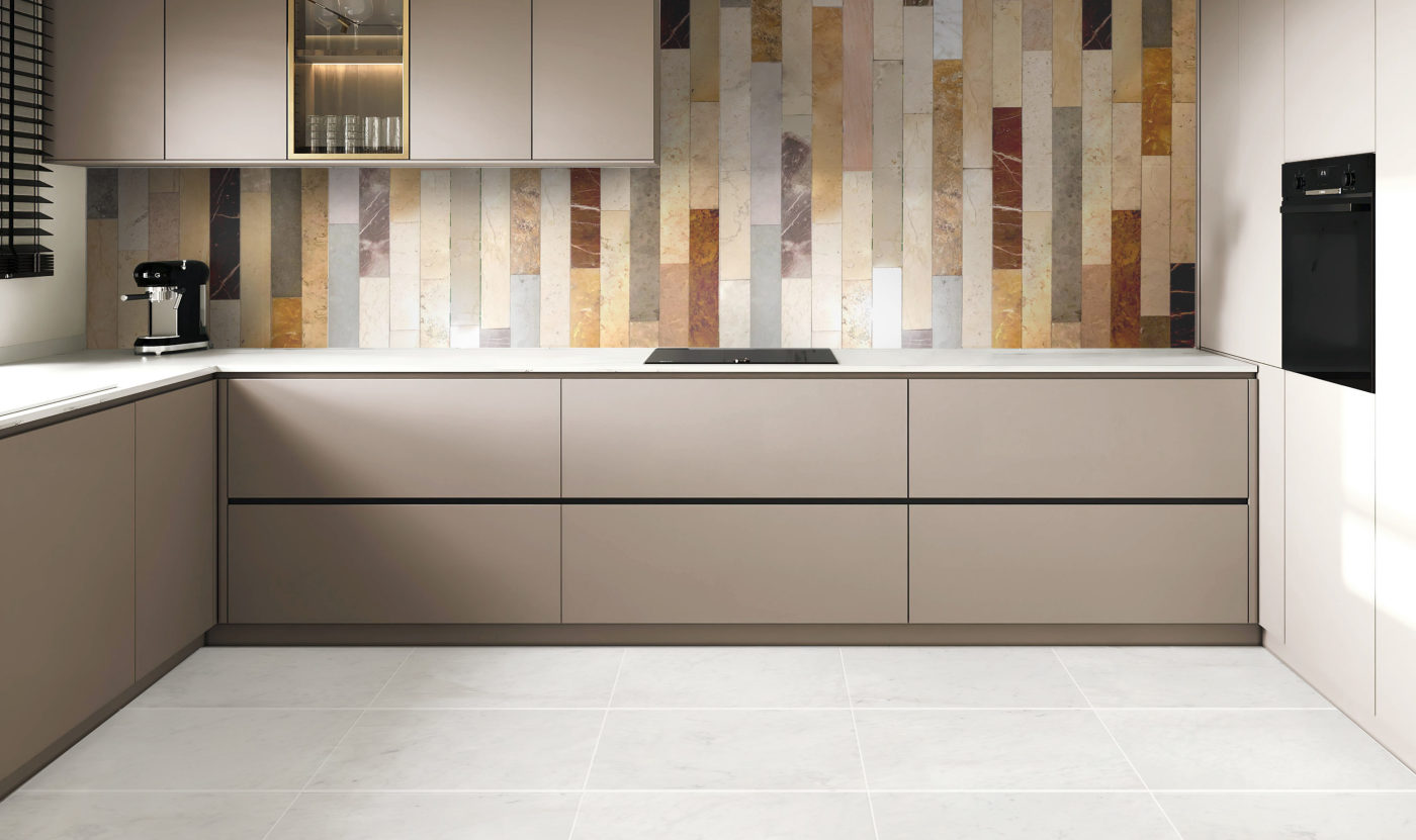 a kitchen with a multicolored tile wall and beige cabinets.