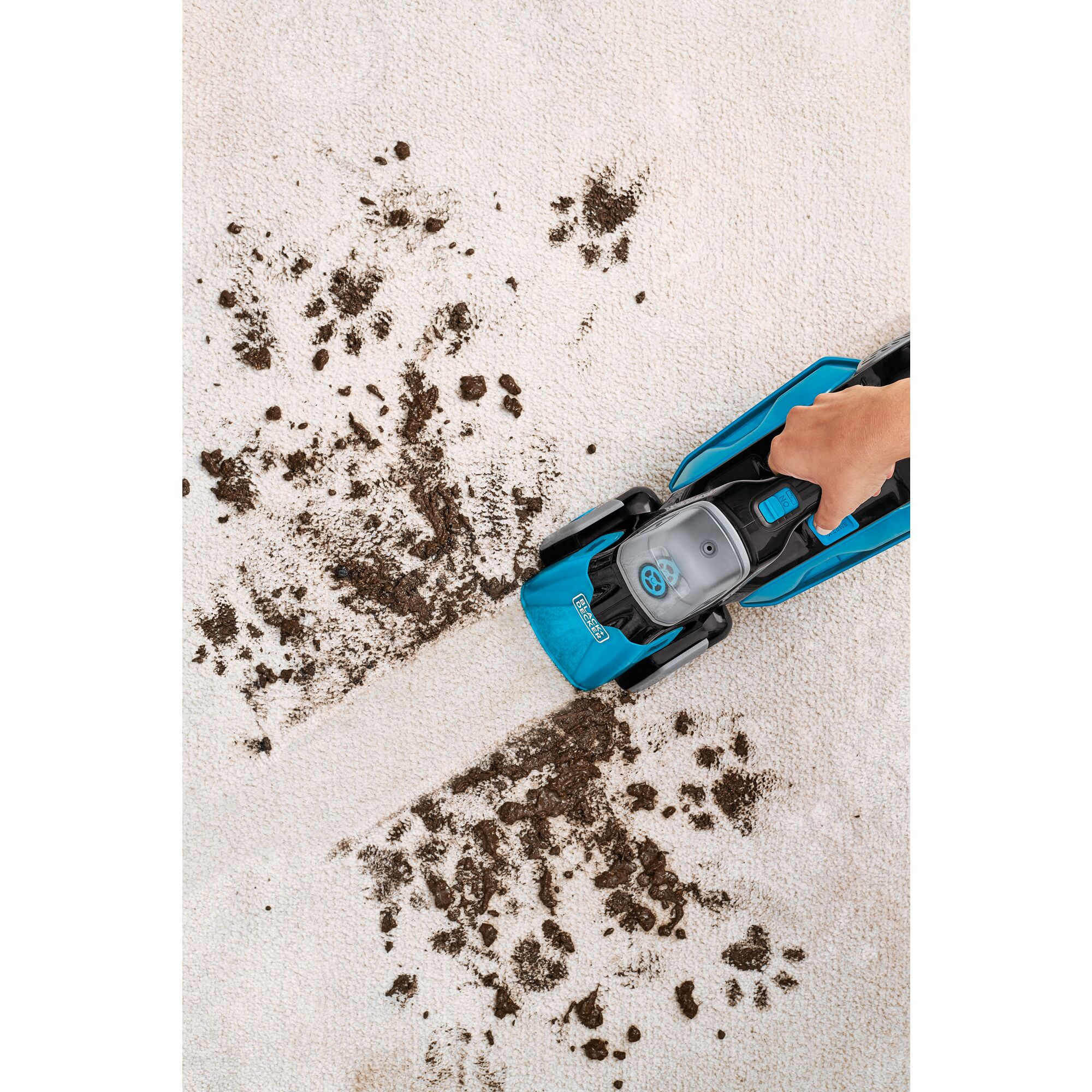 spill buster Cordless Spill plus Spot Cleaner with Powered Scrub Brush being used to clean mud off of carpet.