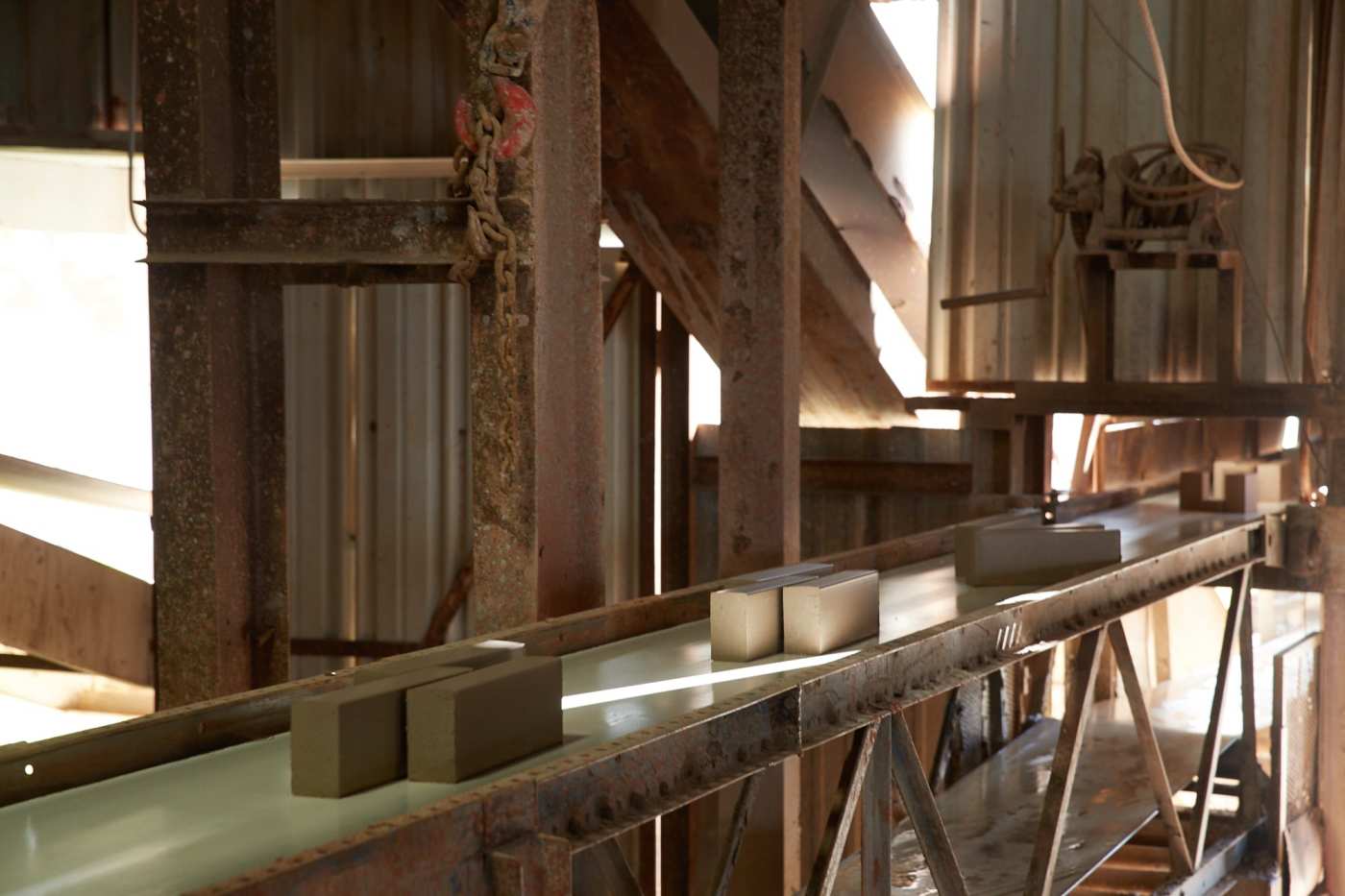 a conveyor belt with bricks in a factory.