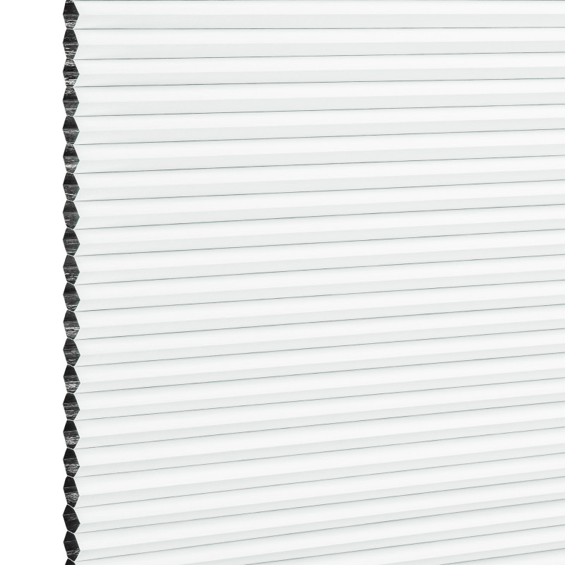 White honeycomb (cellular) window blind with visible hexagonal edge, fully lowered and closed, diffusing bright daylight and covering the window; simple, evenly lit background, no room details.