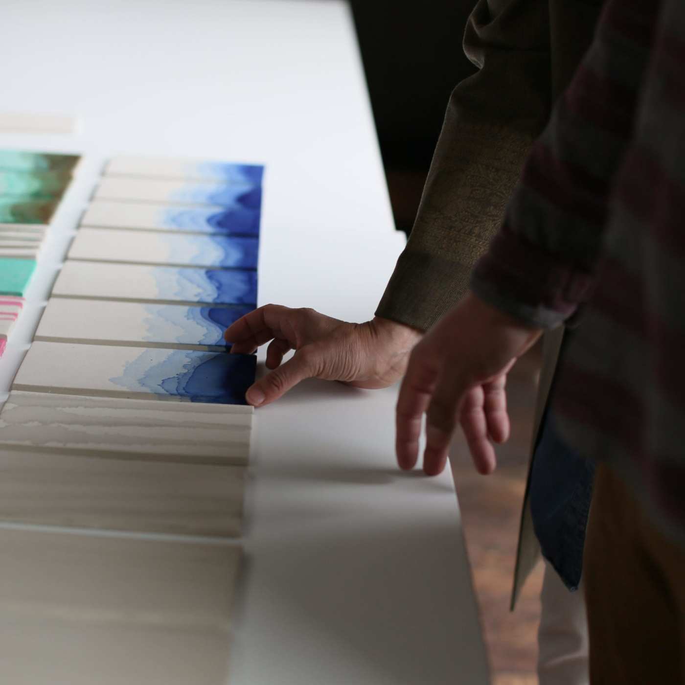 a group of people looking at a table full of paper.