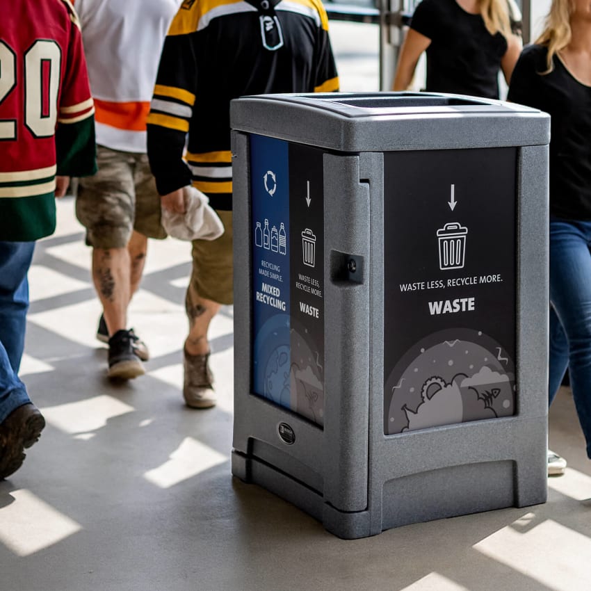 large waste and recycling container with effective body signs located inside an arena facility