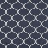 Navy wallpaper with white interlocking trellis/quatrefoil pattern; repeating curved outlines cover the surface; flat, evenly lit backdrop showing subtle linen-like texture.