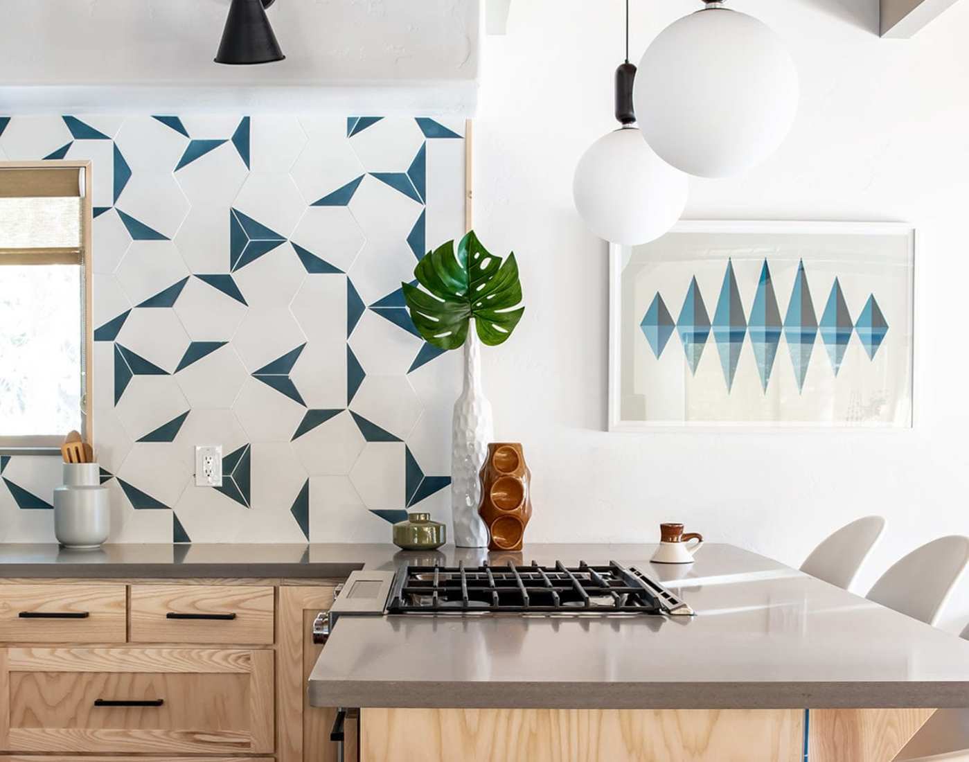 a kitchen with a blue and white tiled backsplash.