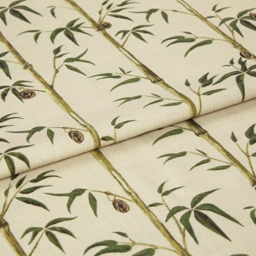Folded fabric sample in cream background with linear print of bamboo shoots and leaves.