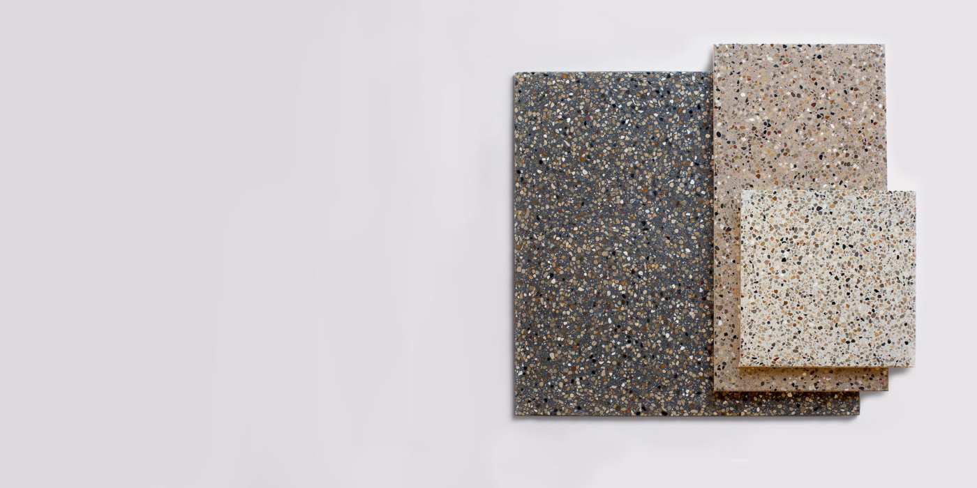 a group of different colored terrazzo tiles on a white background.