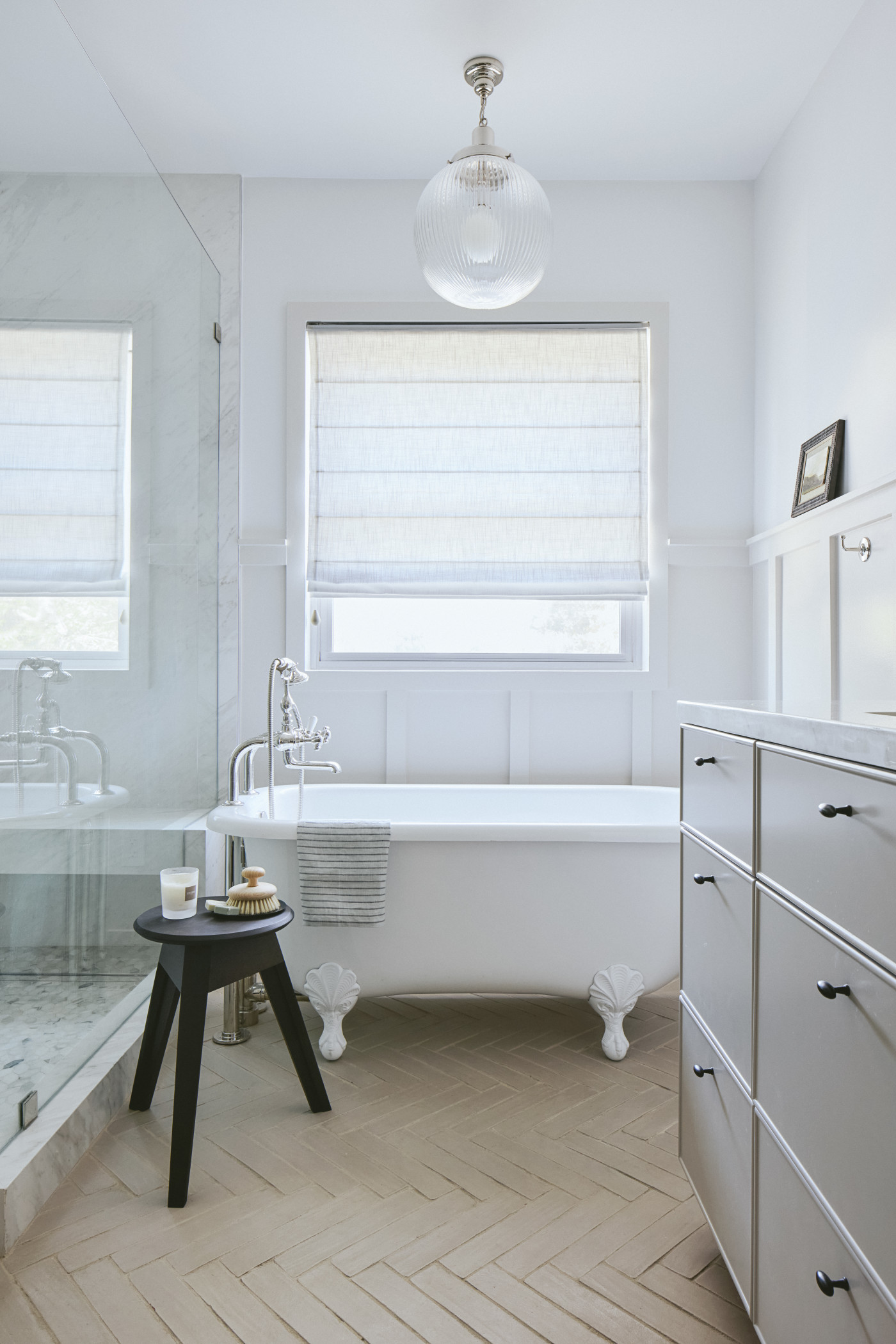 a white bathroom with a bathtub and a sink.