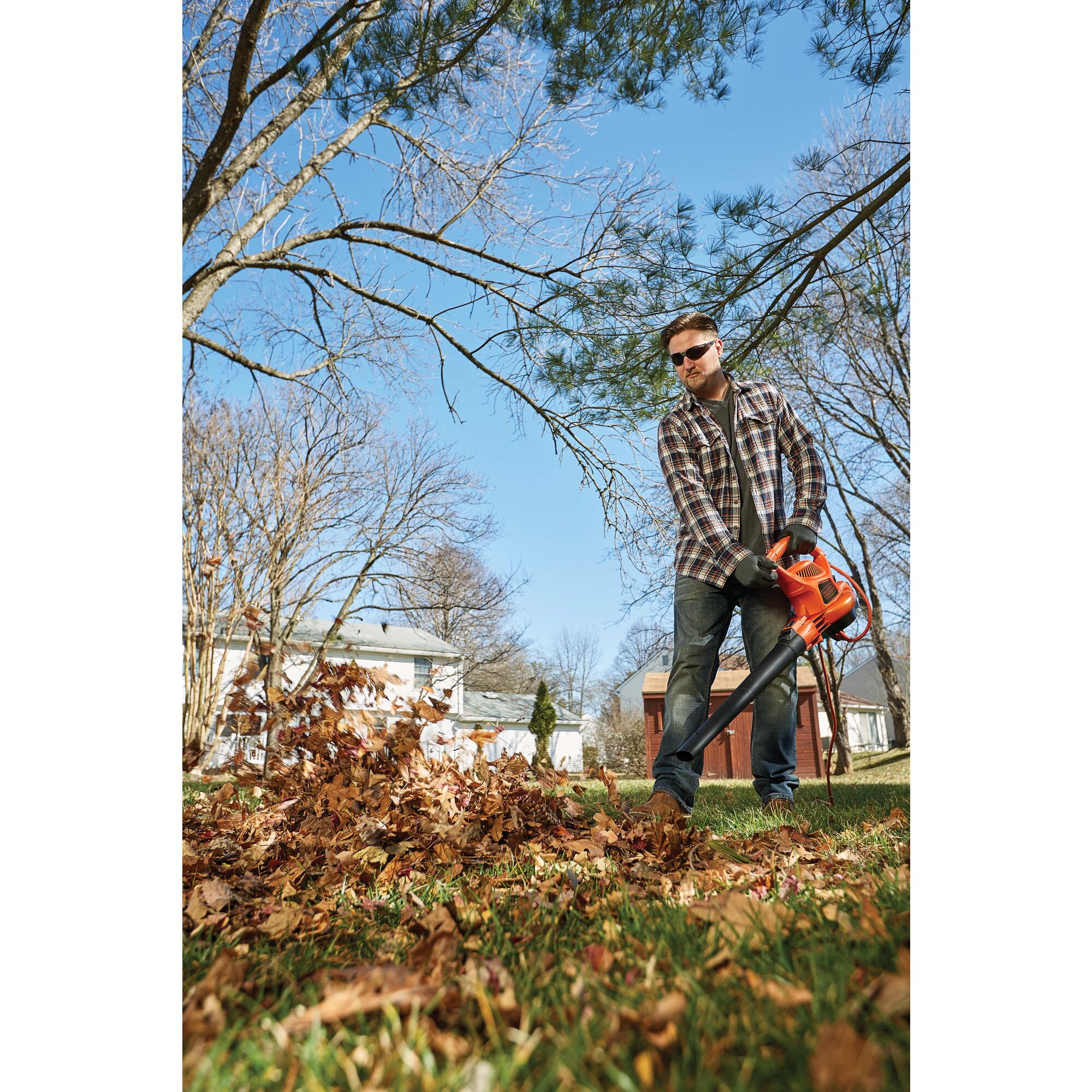 3 in 1 VAC PACK 12 Amp leaf blower, vacuum, and mulcher being used by a person to pick up leaves in yard. 