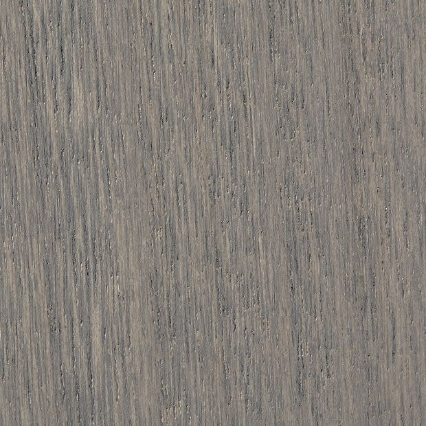 Gray-stained oak veneer with tight vertical grain and subtle knots, showing fine parallel striations and slight weathering, filling the frame as a studio-lit close-up sample.