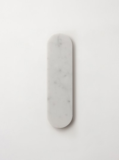 a white marble plate on a white surface.