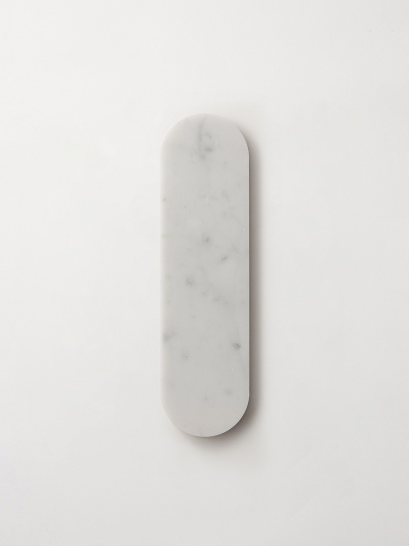 a white marble plate on a white surface.