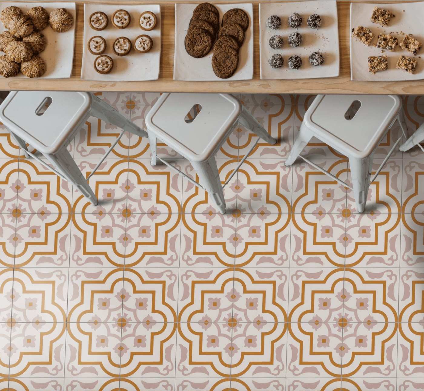 a dining room with a table and chairs and a yellow and white tile floor.