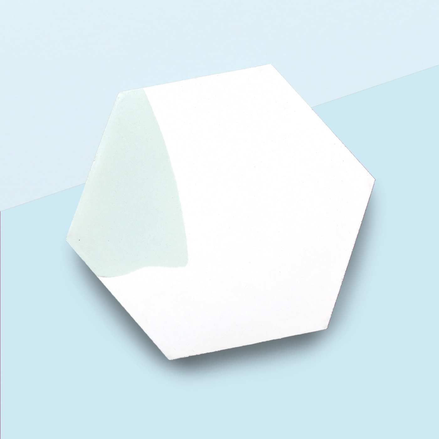 a white hexagonal tile on a blue surface.