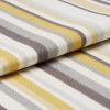 Striped woven fabric with textured knit â€” yellow, gray, beige and white bands â€” folded over itself, close-up on a flat surface under soft studio lighting.