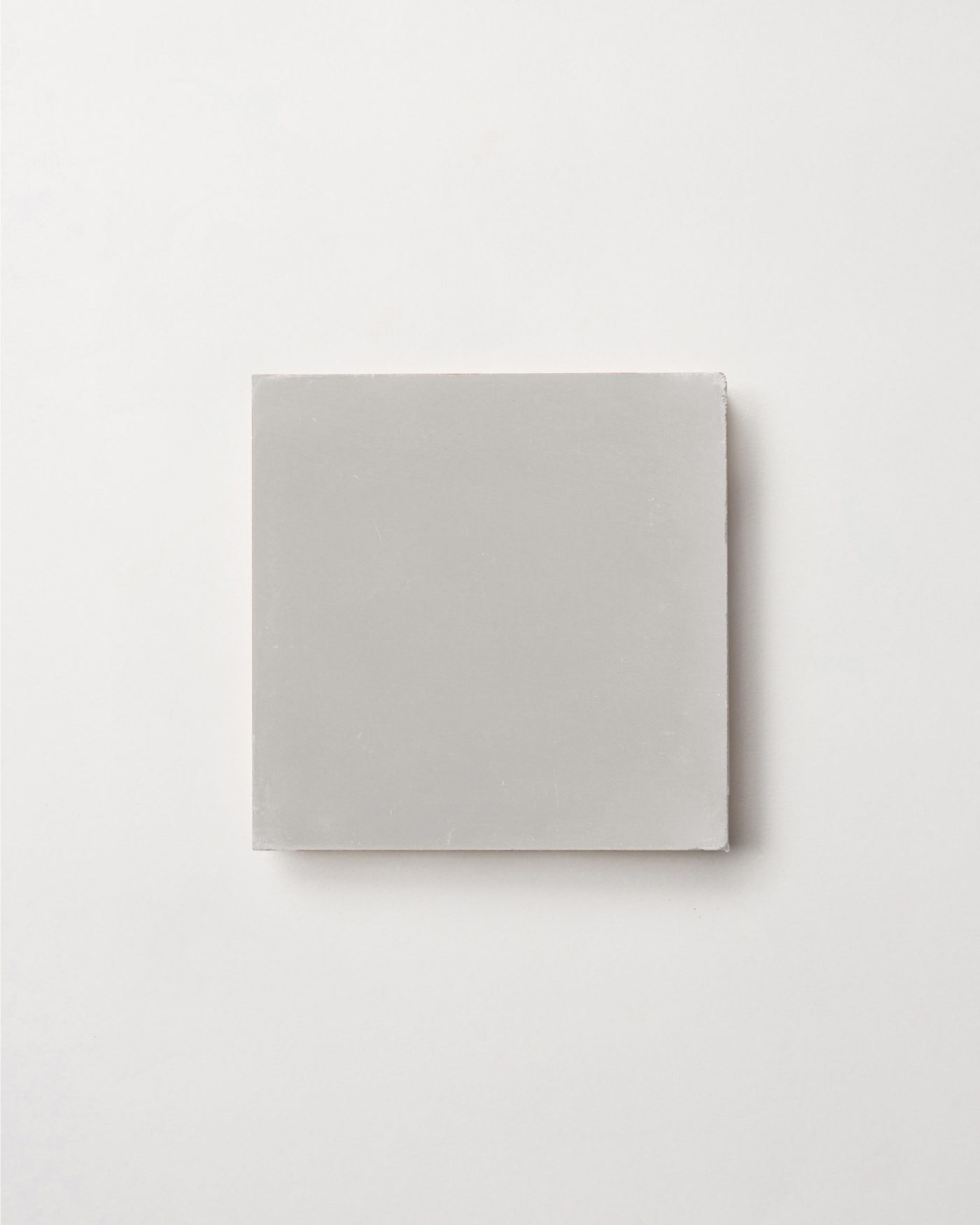 a grey square tile on a white background.