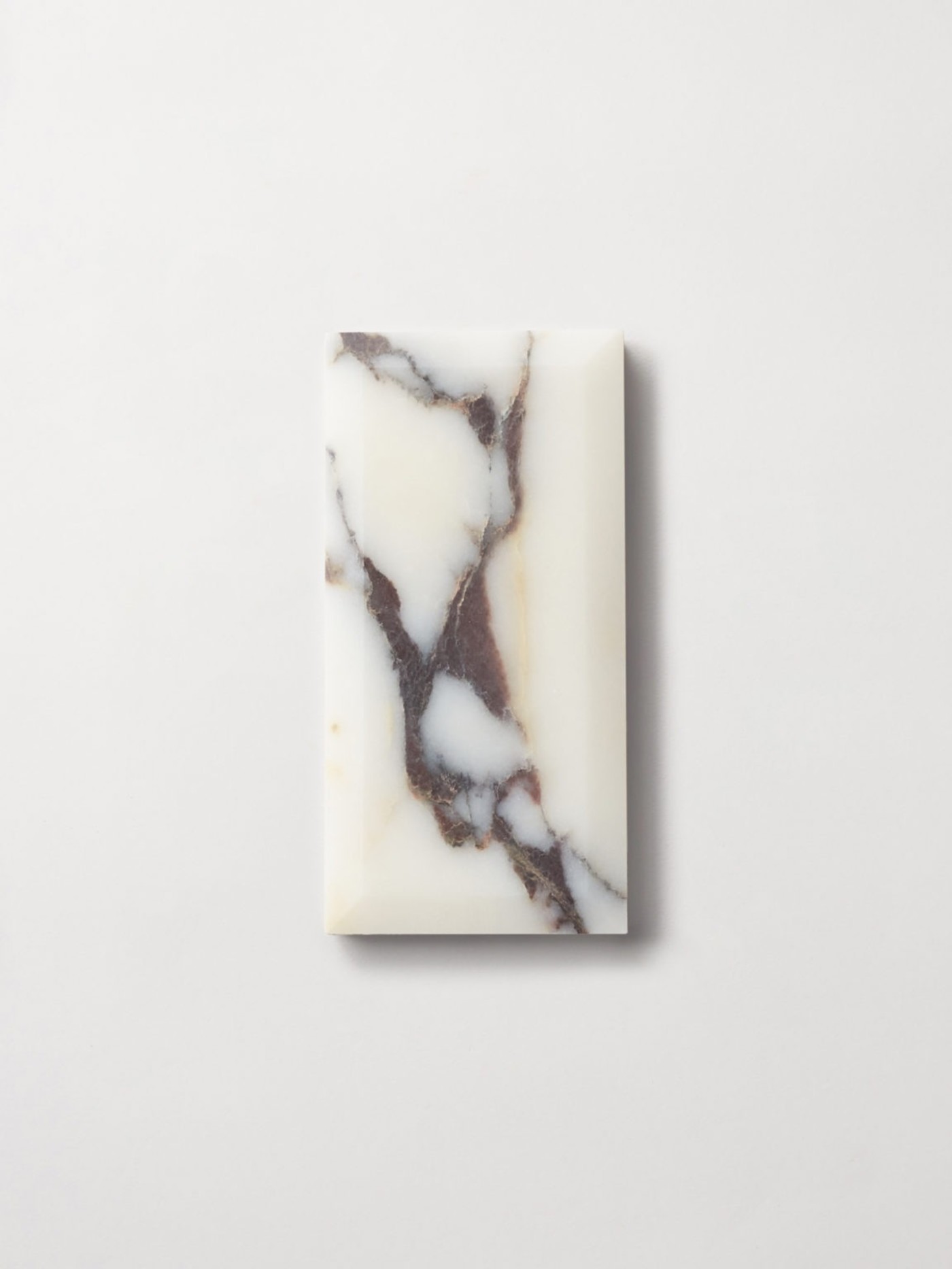 a marble tile on a white surface.