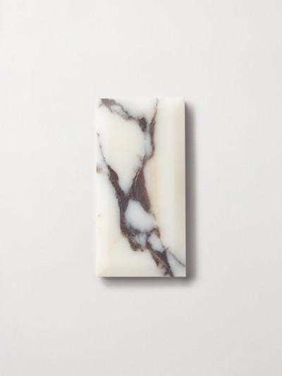 a white marble soap bar on a white surface.