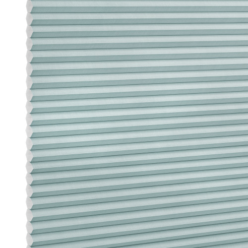 Honeycomb (cellular) shade, light-teal horizontal pleats, fully lowered; closed, softly diffusing light; close-up studio view against a white background.