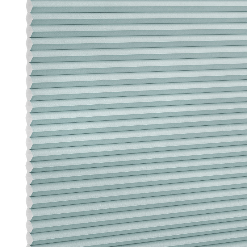 Honeycomb (cellular) shade, light-teal horizontal pleats, fully lowered; closed, softly diffusing light; close-up studio view against a white background.