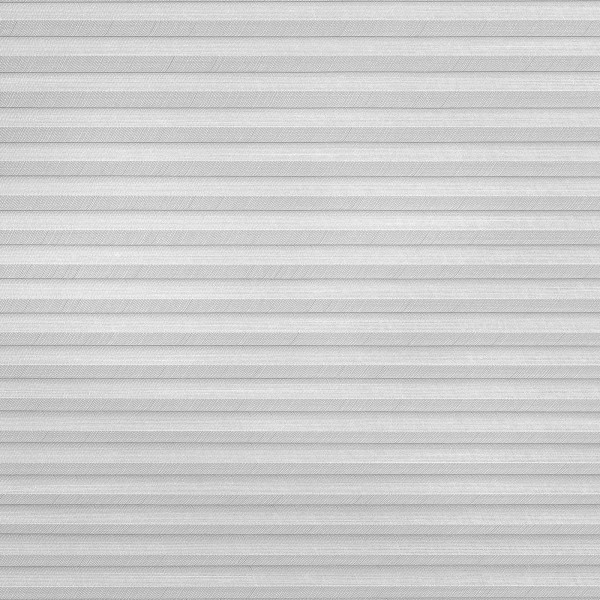 Light-gray pleated (cellular) blind covering the whole window frame, horizontal textured ribs; closed and filtering soft diffuse light; set in a neutral, evenly lit interior with no visible view.