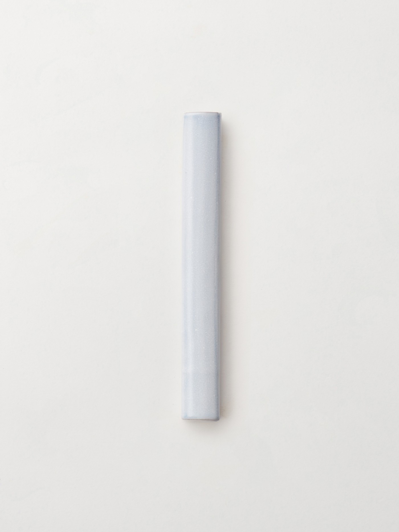 a long, thin white tile on a white surface.