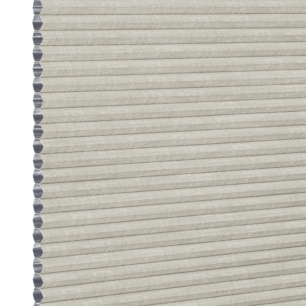 Light beige honeycomb cellular shade with pleated fabric and exposed hexagonal cell ends at left, fully lowered and closed, concealing view; close-up product-style shot on white background with even lighting.