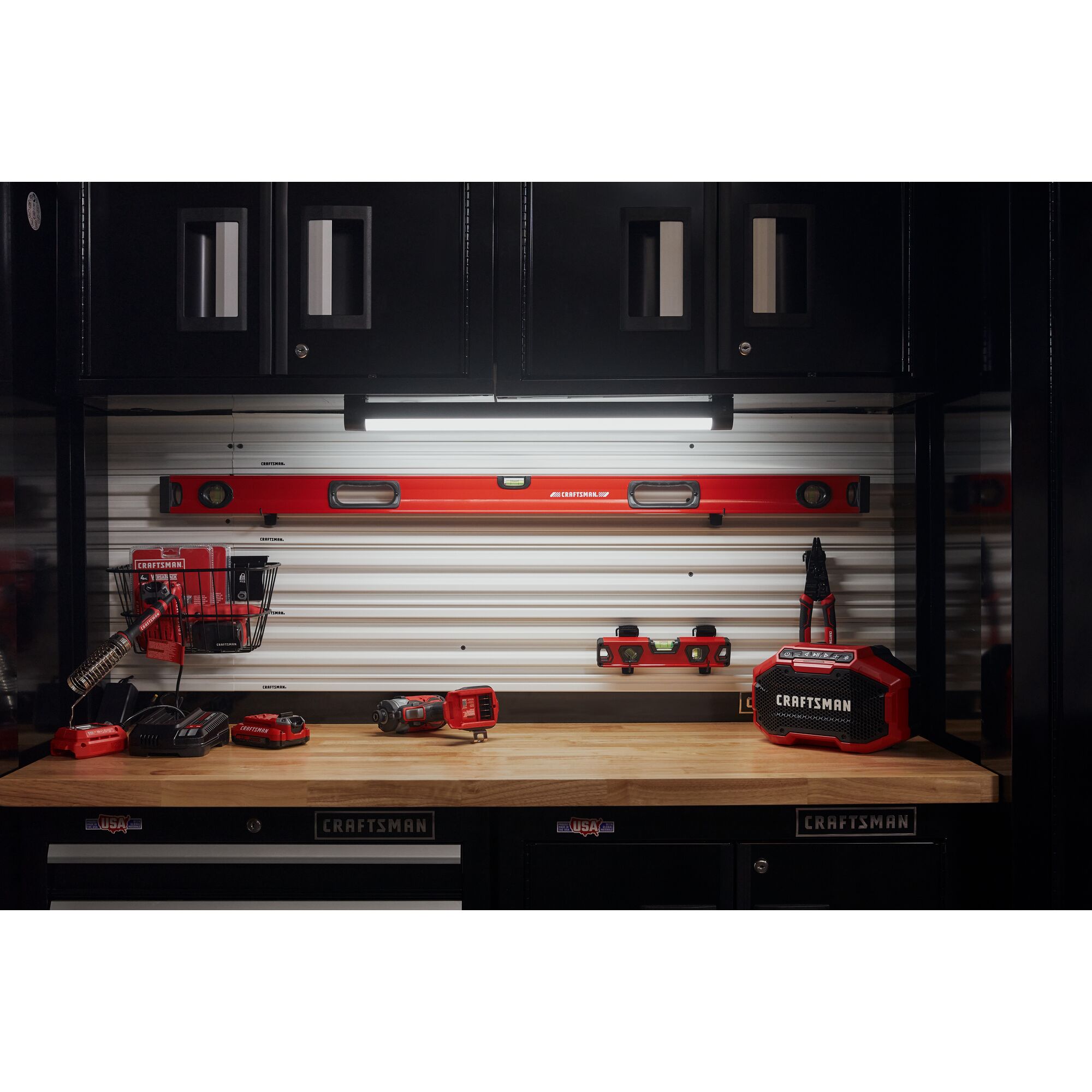Variety of hand tools, power tools laying on CRAFTSMAN storage.
