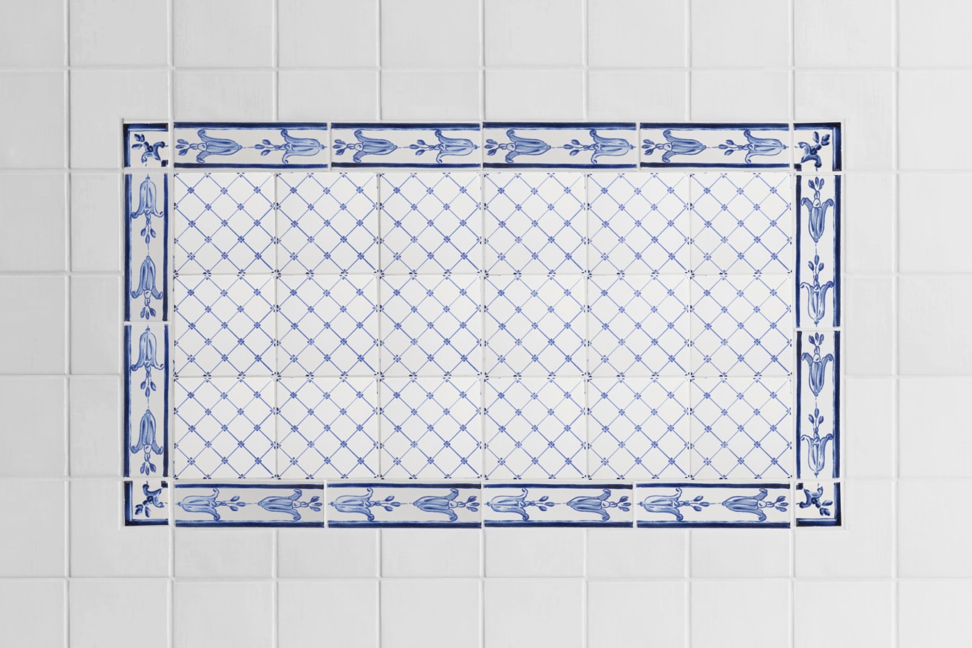 a blue and white tiled wall in a bathroom.