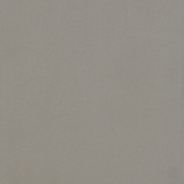 Light-gray textured sheet or wall sits flat and unadorned, filling the frame under even diffuse lighting, with subtle speckling and a faint vertical edge visible.