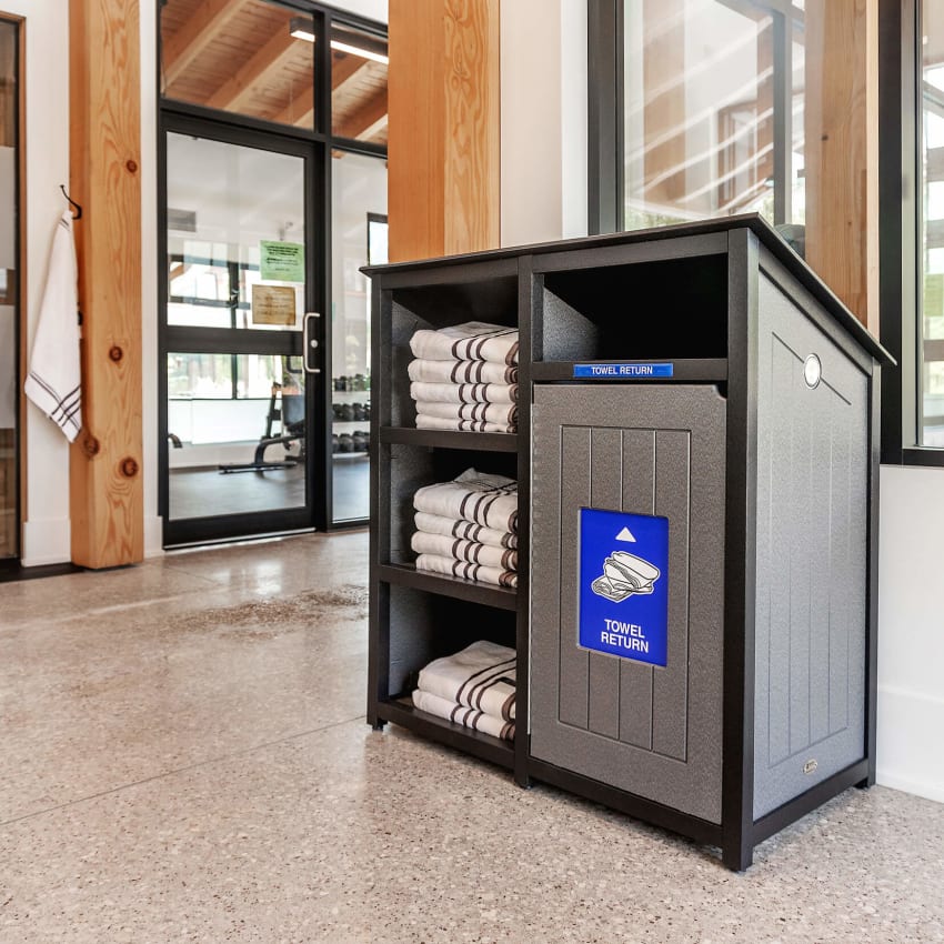 black and grey towel shelf and towel return station indoors at a gym and sauna