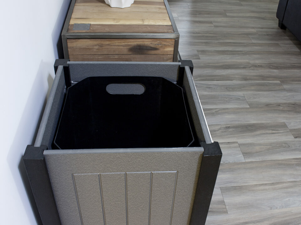 overhead view of waste container with the lid removed showing the plastic liner inside sitting in a modern office